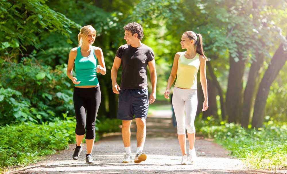 a-group-of-teenagers-walking-and-exercising-outside