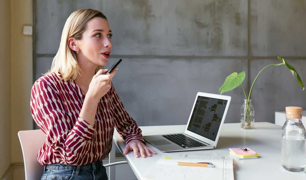 a-woman-talking-on-her-phone-working-remote